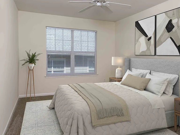 Bedroom with large window and ceiling fan