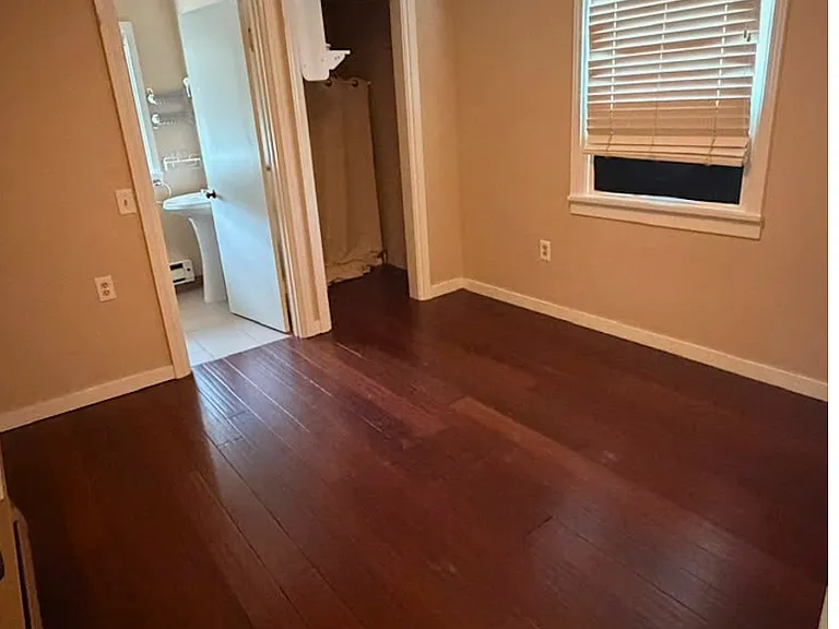 Gorgeous wood floors in the bedroom with an ensuite bathroom.