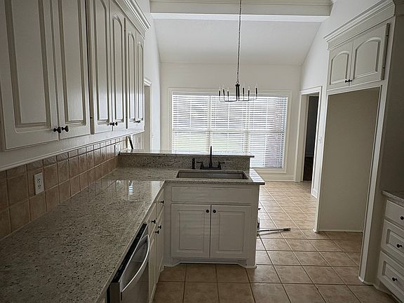 Kitchen with new range, dishwasher and microwave.