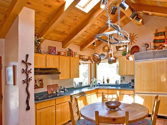 the home's main door opens to the kitchen w/skylights, a pitched roof w/wd