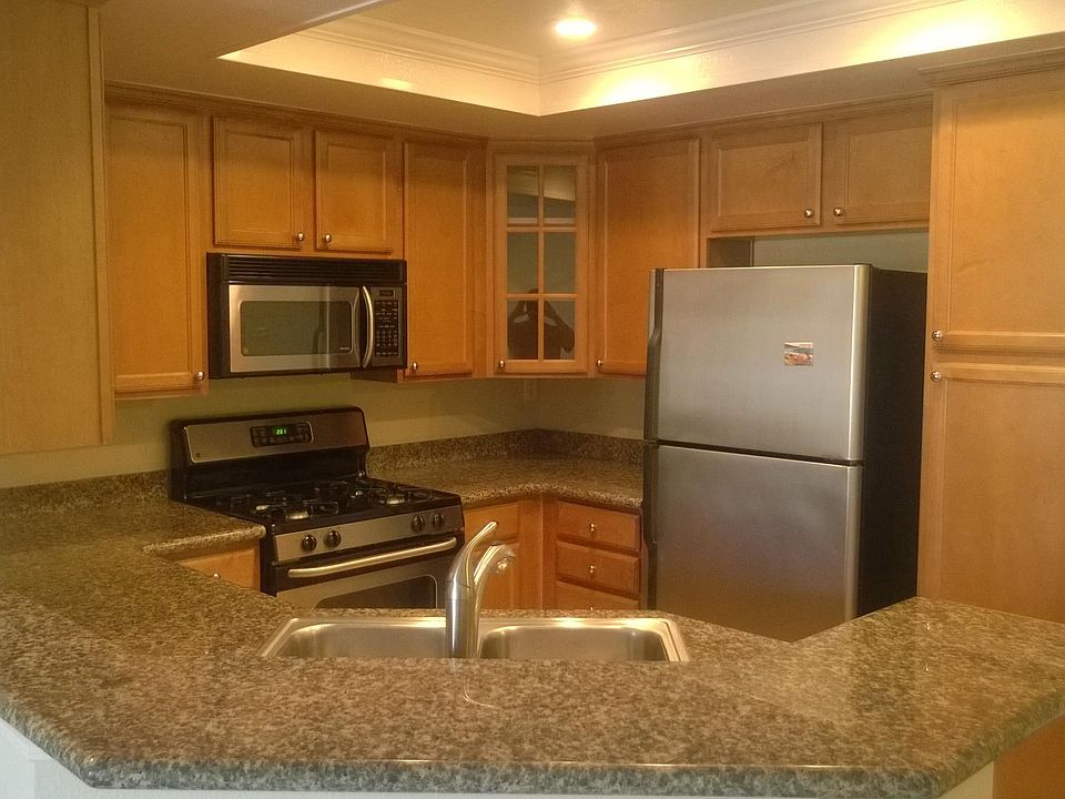 Kitchen with granite counter tops, gas stove, and stainless
