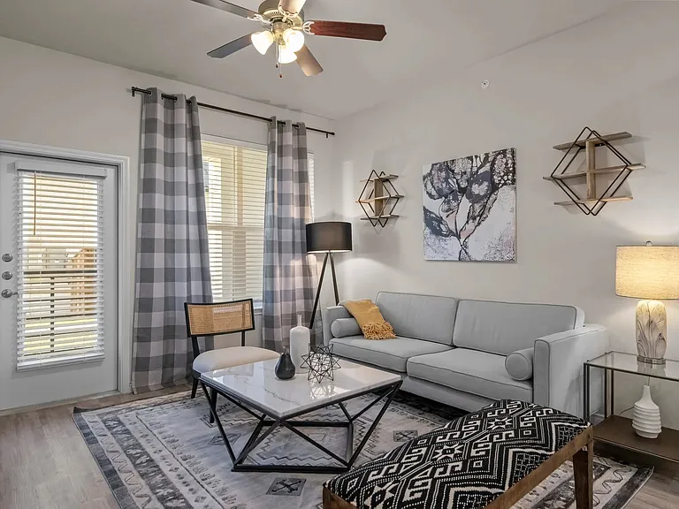 Welcome to Southgate Apartments, where modern comfort meets stylish design. This spacious living area features chic decor and plenty of natural light, perfect for relaxation and entertaining. Schedule your visit today to see your new home!