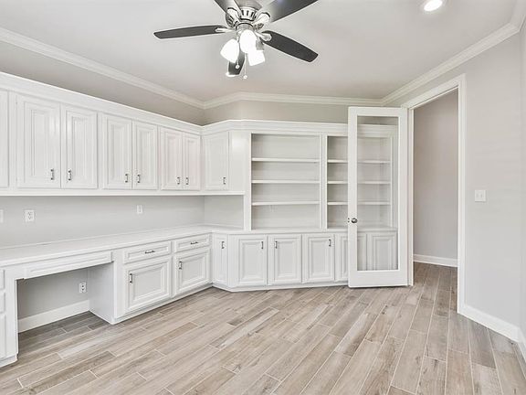 The Study/library showcases built-in bookshelves, and Tile-Wood floors