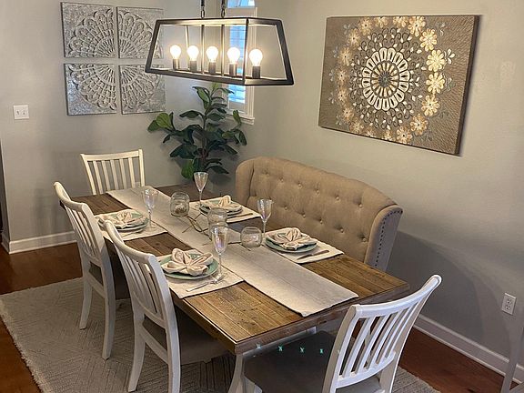 Enter in the dining room, which is open to the living and kitchen space.
