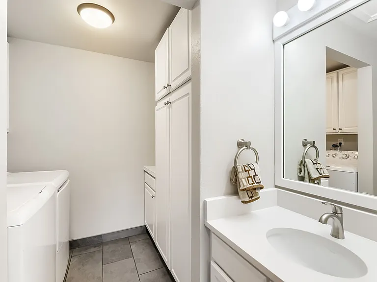 Main level wash room and storage with laundry.