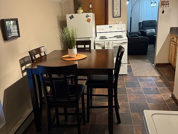 Kitchen view with table and chairs and decor.
