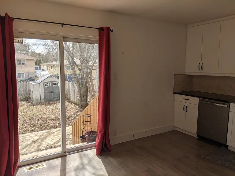 Kitchen has patio doors leading out to the spacious backyard.