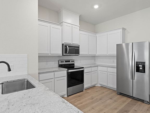 The kitchen of the Noma has beautiful white wood cabinetry.