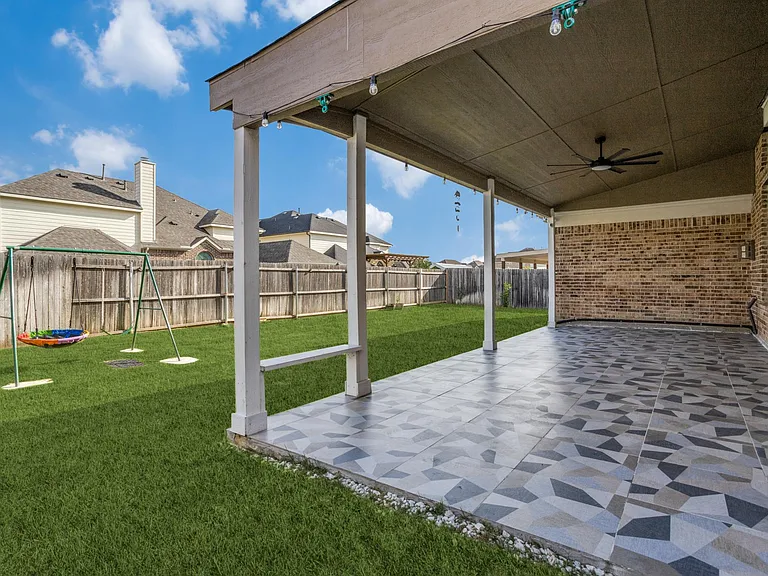 View of patio featuring ceiling fan