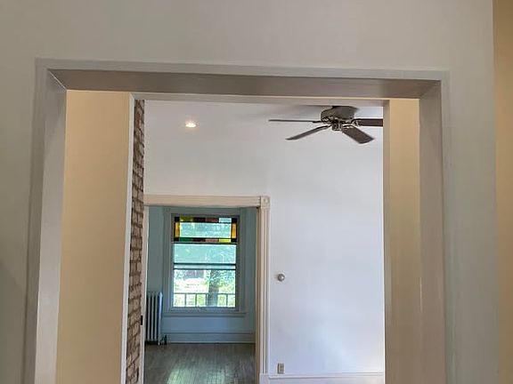 view from kitchen to bedroom and thru living room