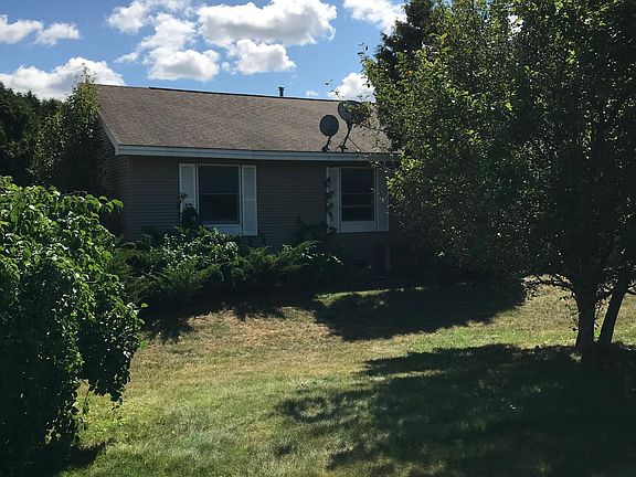 Back yard view. Trees & shrubs. Yard is maintained & watered, as well as snow removal in driveway & roadway.