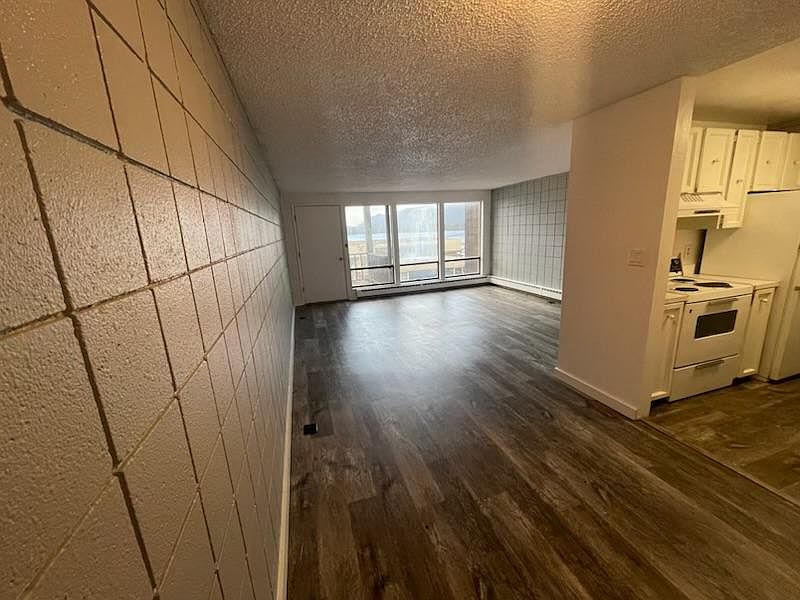 Large main living area with new paint and flooring and big windows looking out to the beautiful view of Tongass Narrows