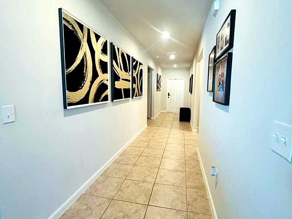 Wide hallway with clean design and easy access to all rooms.