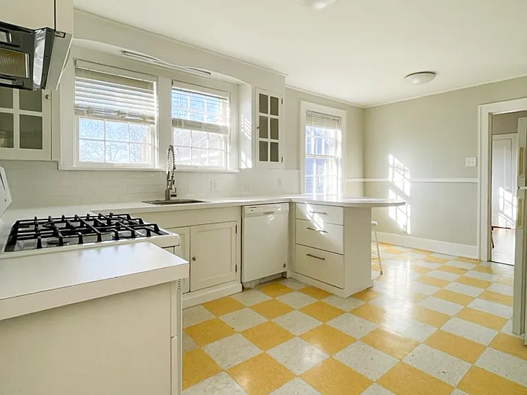 Large kitchen with modern appliances, dishwasher, and garbage disposal.