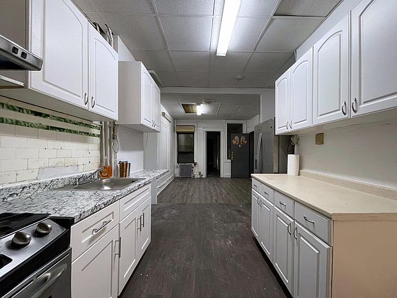 View of kitchen into the living room leading to the den