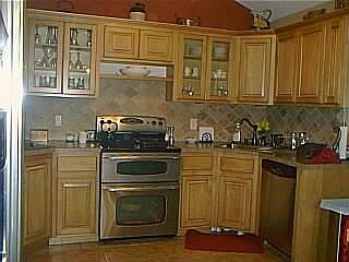 Kitchen w/vaulted ceilings & stainless steel appliances