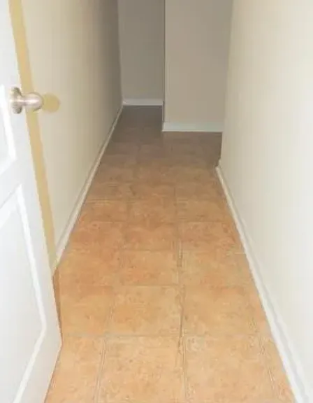 Storage area under the stairs to basement