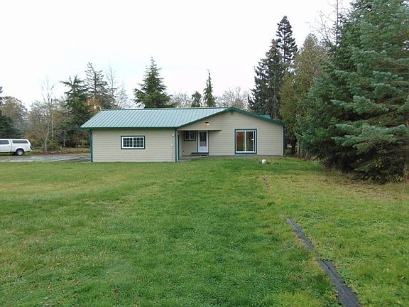HUGE backyard that now has a fence on the right side and a firepit. There are raised garden beds here as well that are not shown.
