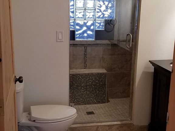 Master Suite bath - -Newly tiled 2 shower heads 7' X 3' shower, 2 sink vanity on right and toilet