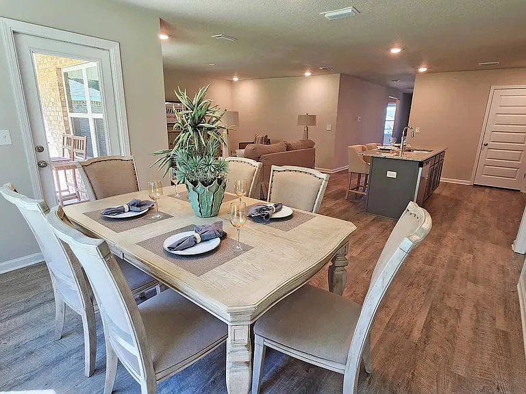 Dining room overlooking kitchen & living room. Backdoor is located off of the dining room and opens to a covered porch area.