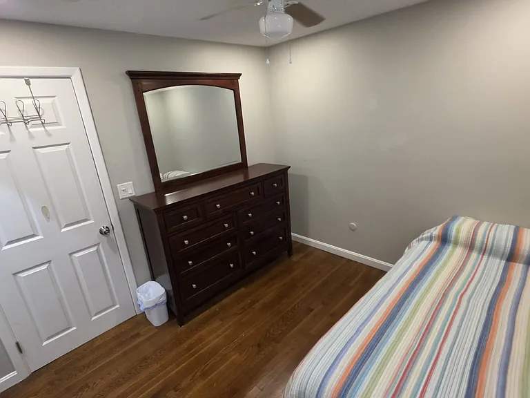 4th bedroom with single bed, dresser and ceiling fan.