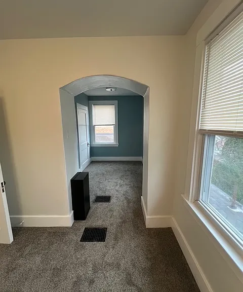 Spacious bedroom/nursery including 2 closets, updated paint and brand new lighting. Laundry chute located in the middle of the bedroom.