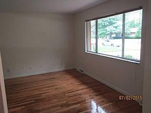 Living Room. Tons of light come through big windows in the living room. Custom made to fit blinds.