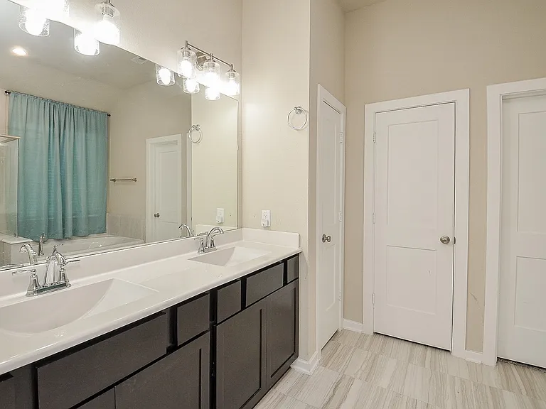 Primary/Master bathroom. Tile floors, plenty of storage.