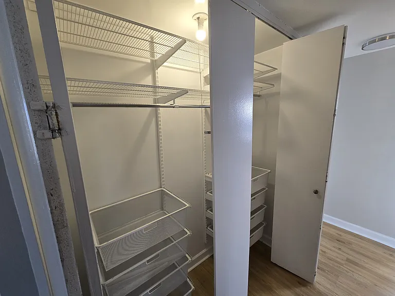 Elfa closet system in hallway closet