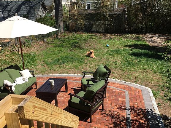 Exit to back yard and large back patio with webber grill