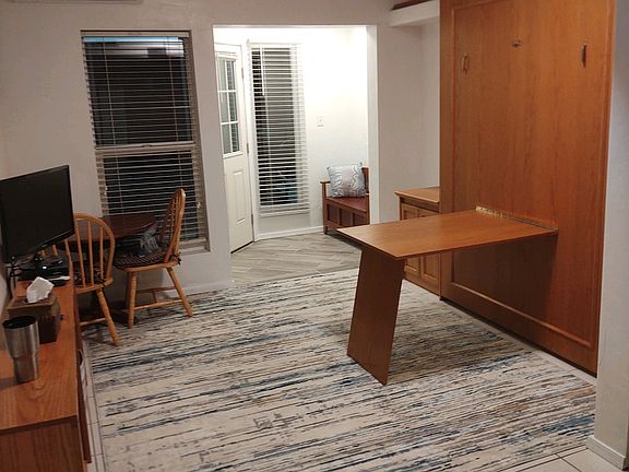 Front room, with bed up and desk down.