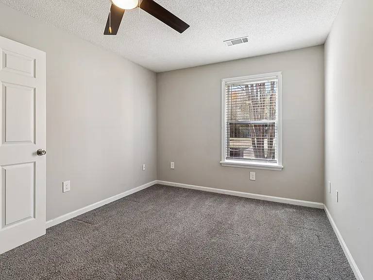 Comfortable rooms feature ceiling fans for climate control and window blinds for privacy, professionally operated by Highlands Vista Group.