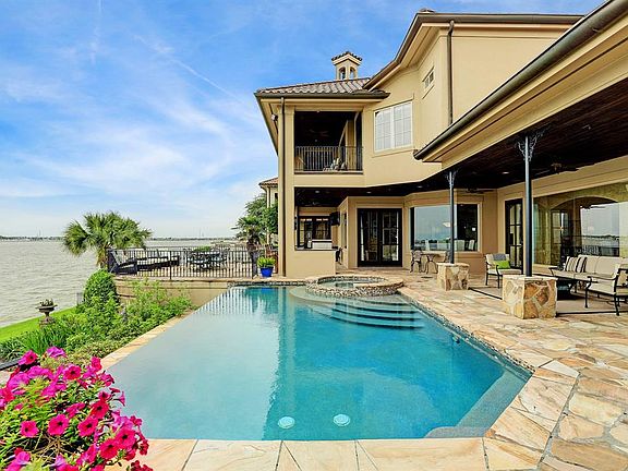 LOUNGE BY THE INFINITY POOL OVERLOOKING CLEAR LAKE, ENJOY THE COVERED VERANDA, RELAX BY THE LAKESIDE FIREPIT OR ENTERTAIN BY THE LAKESIDE PATIO AND OUTDOOR KITCHEN! THE OUTDOOR AMENITIES ARE COUNTLESS.