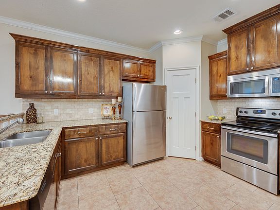Fabulous kitchen with stainless steel appliances, granite counters and a walk in pantry. Tile floors