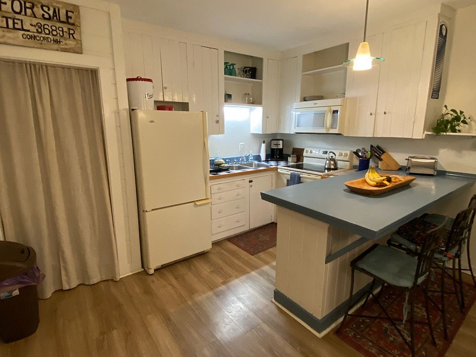 Kitchen w/ extra pantry storage behind the curtain
