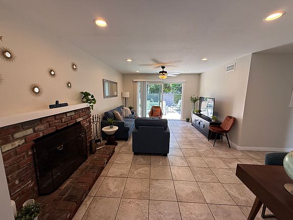 Living room with fireplace and sliding door to large private patio yard