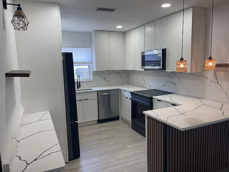Looking to the kitchen from the 1st bedroom door.