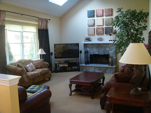 sun drenched family room features back staircase