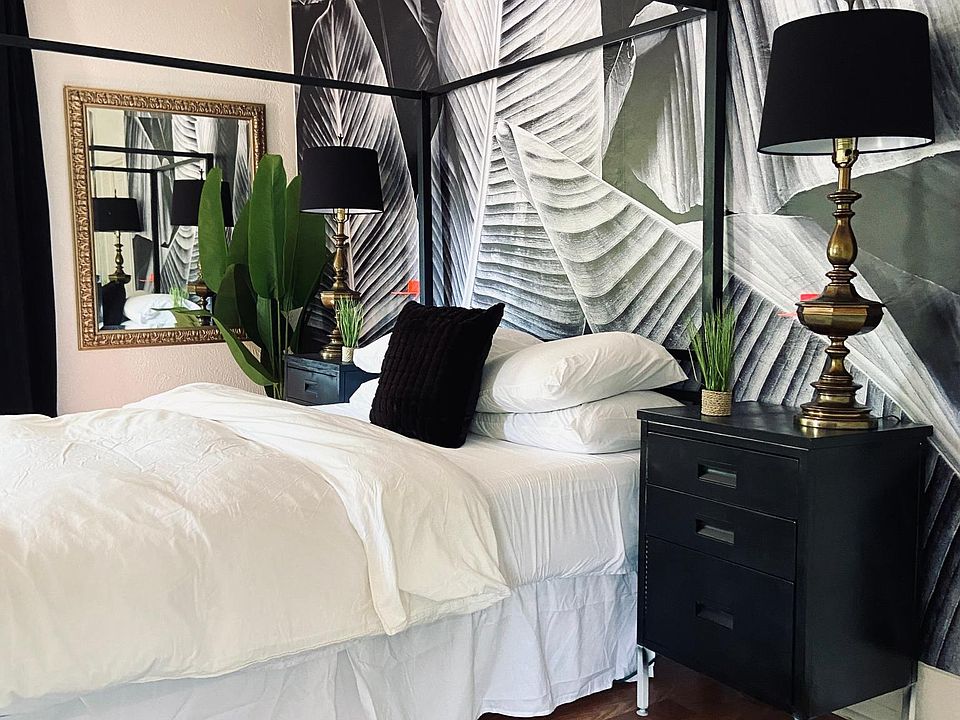 Spacious Primary Bedroom with Neutral Tropical Decor and comfortable, soft linens