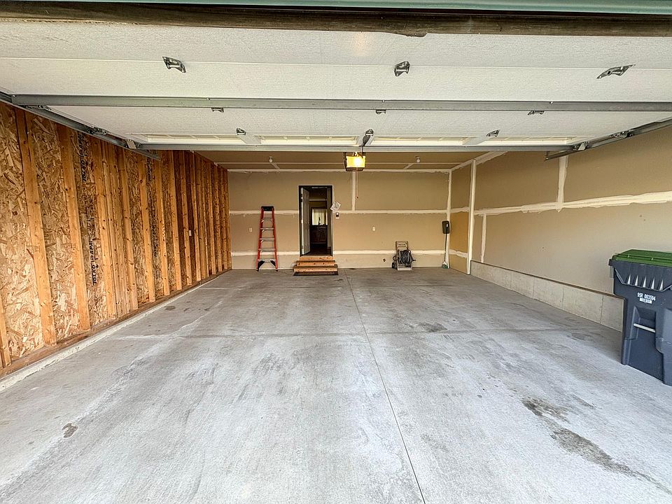 Spacious two car indoor garage showing entry door to the house