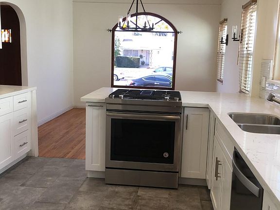 Stainless steel dishwasher, sink, kitchen faucet, stove (garbage disposal too), and newly updated cabinets/hardware make this a great kitchen for entertaining as it opens up to the lovely dining area and out to the side patio for dining al fresco!