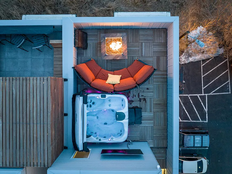 Our rooftop deck is the ultimate chill spot. Keep warm even in the winter months with the luxury fire pit and hot tub. Extra jets provide aqua massage and in addition to the circular couch, there are camp chairs to provide ample seating for groups!