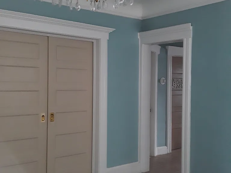 Dining room separating living room, brown sliding doors are to go into bedroom 2 or use door by the bathroom