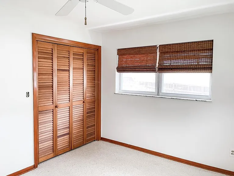Bedroom #2 with windows looking to side of house & back yard + full closet. Freshly painted with new blinds.