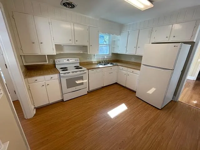 Freshly painted kitchen cabinets and new refrigerator, range and dishwasher.