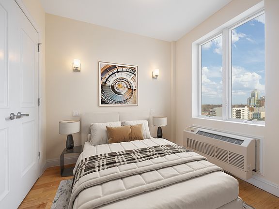 a bedroom with a bed and a large window