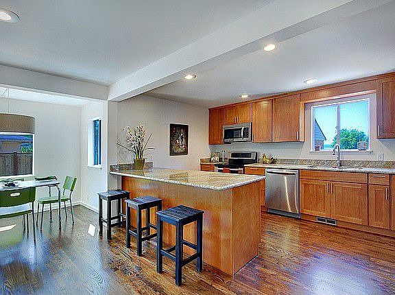 Large breakfast bar, sound and mountain views from west facing windows, and high-end stainless steel