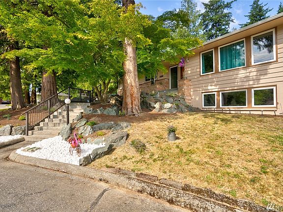 Mature trees provide shade and privacy to front of home.