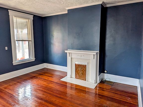 Features hardwood floors, large windows for natural light, and 10-foot soaring ceilings throughout the apartment.