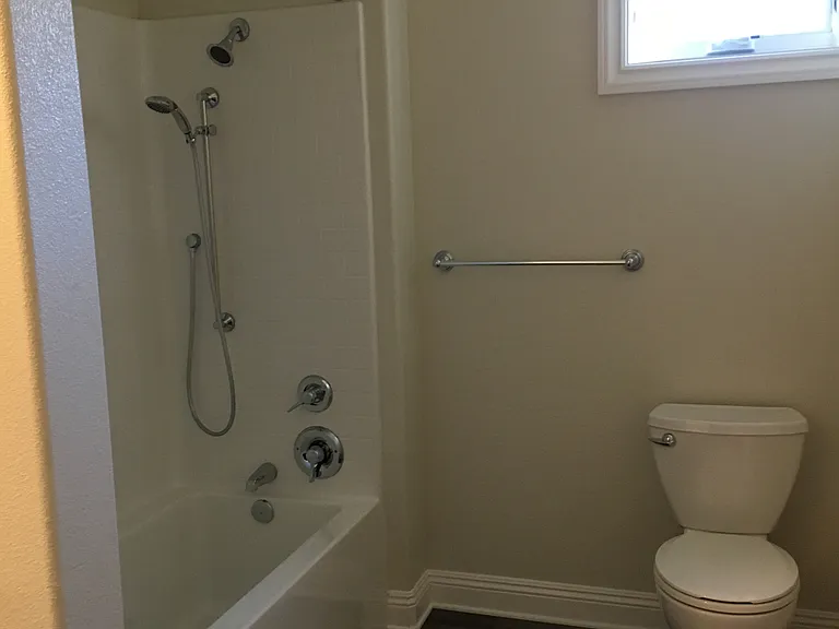 High pressure dual head shower with curved shower curtain rod for added